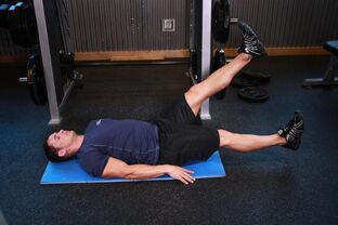 Man with prostatitis performs an exercise in the gym